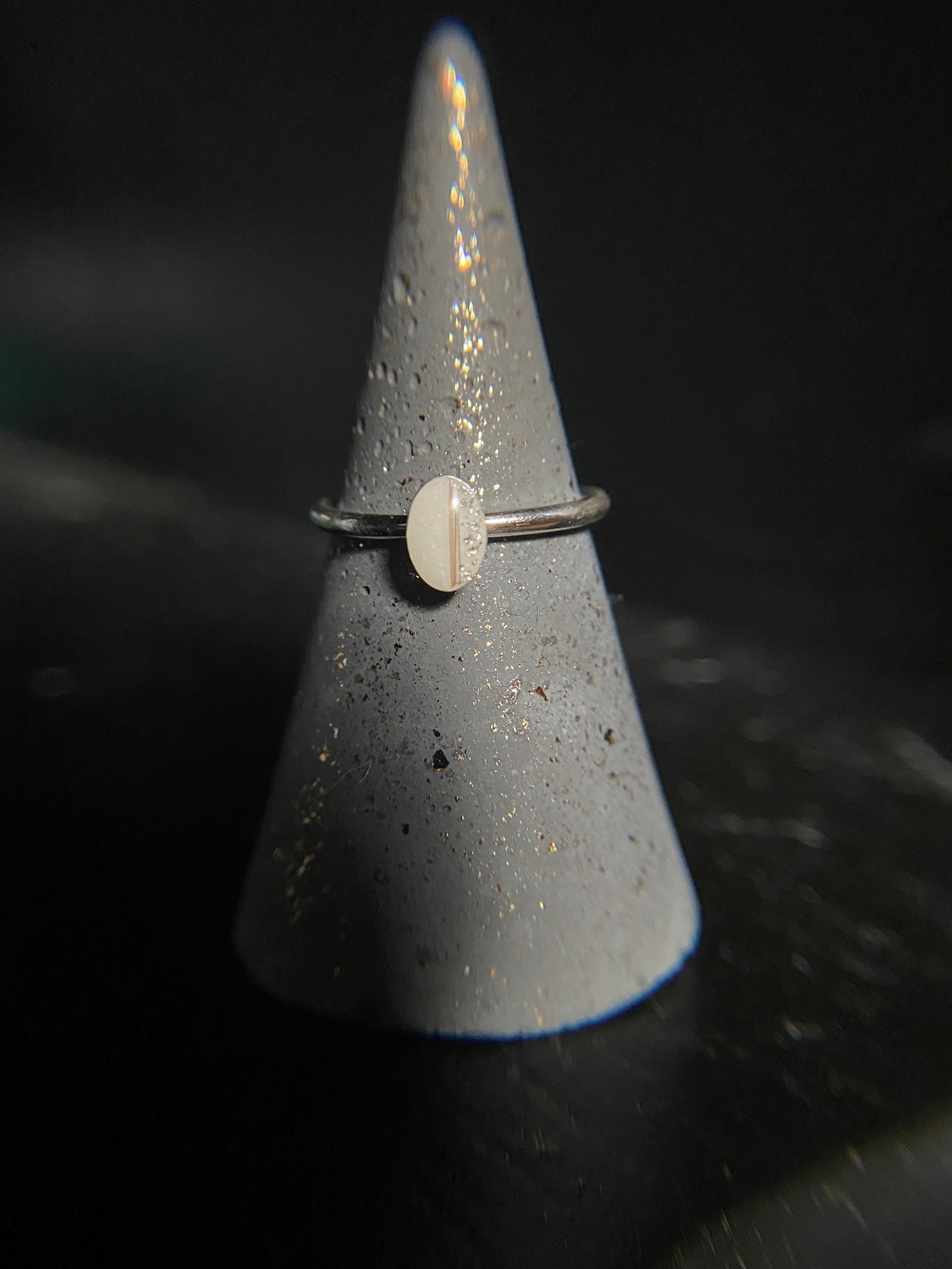 Ainsley oval ring holding breastmilk or ashes, designed as a crystal-infused memorial keepsake
