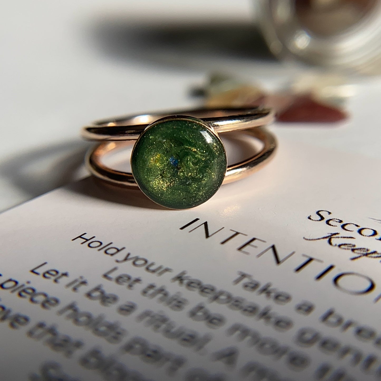 gold filled with cremation ashes in green with an 8mm round circle bezel and a double band in gold