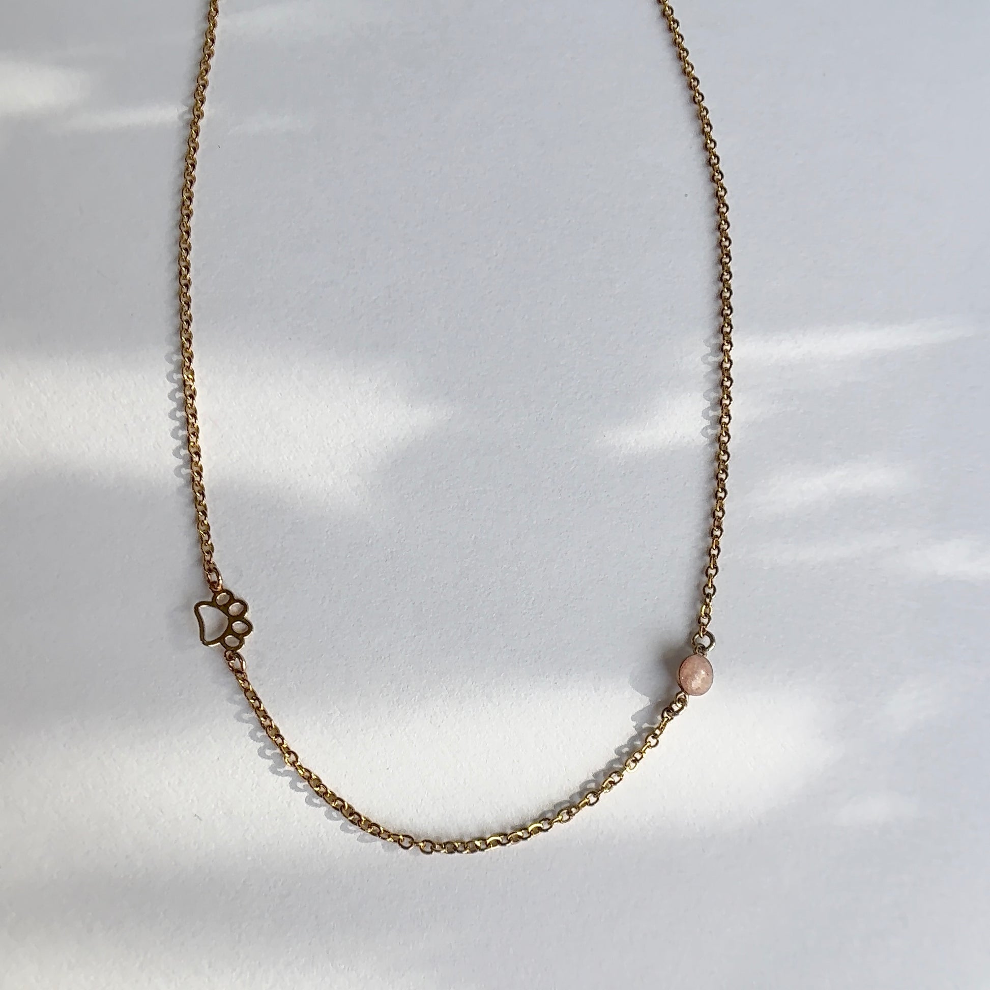 paw print and cremation ash necklace in gold