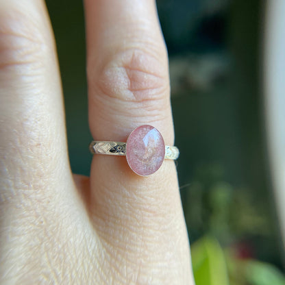 silver floral band on finger with pink ash stone